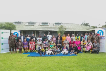 A group photo of the Kingdom Bank team, MWAK officials, KDF Service Men and Women and beneficiaries of the diaper distribution programme.