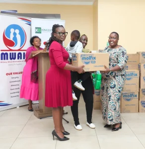 Millicent Madegwa, Head of Institutional Banking participates in the handing over of diapers at the event.